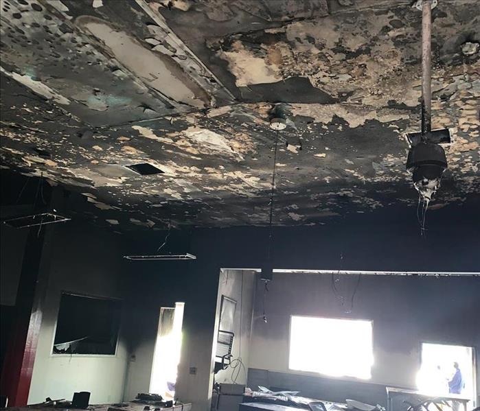 Ceiling with extensive fire and soot damage.