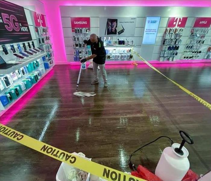 Man moping floor. Man cleaning floor after water damage